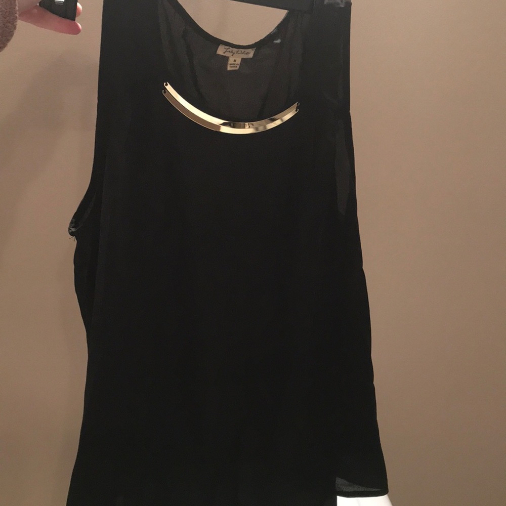 Black sheer sleeveless top with gold accessory